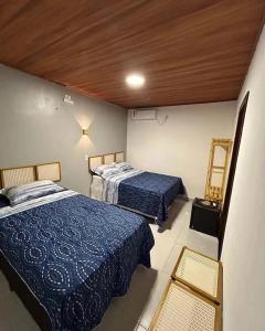a room with two beds in a room at Essência de Atins in Atins