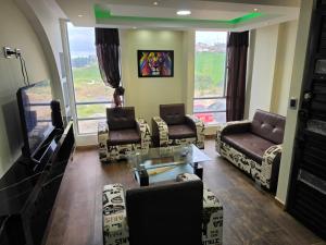 a living room with couches and a flat screen tv at Torres buambiles 2 in Ipiales +9 photos