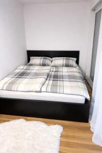 a bed with two pillows on it in a bedroom at Modern Nature Apartment ! WIFI & Parking Free ! in Frauenfeld