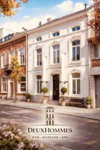 a white building on the side of a street at DEUXHOMMES Boutique B&B Massage&Spa in Hasselt