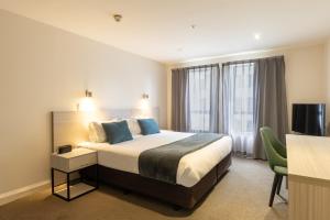 a hotel room with a bed and a television at Quest Cathedral Junction Serviced Apartments in Christchurch +60 photos