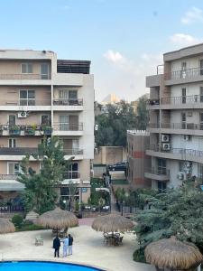 a group of people standing in front of a building at Pyramid View Apartment near GEM in Ghaţāţī