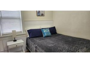 a small bedroom with a bed and a window at #7 Kipling Cottages Last Resort on Lake Michigan in Gladstone