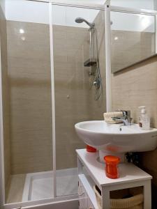 a bathroom with a sink and a shower at ANTONELLI Apartment L'AQUILA in LʼAquila +18 photos