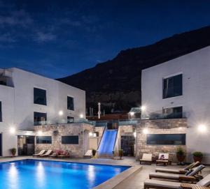 a villa with a swimming pool at night at Avis 2 in Igalo