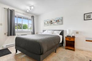 a bedroom with a large bed and a window at Homeport Motel in Lunenburg