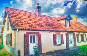 a house with an orange roof with a chimney on it at Maison de charme solognote in Neung-sur-Beuvron