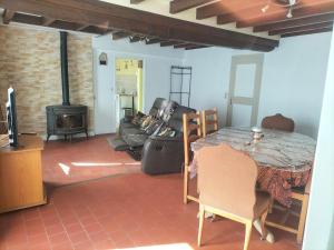 a living room with a table and a fireplace at Maison de charme solognote in Neung-sur-Beuvron