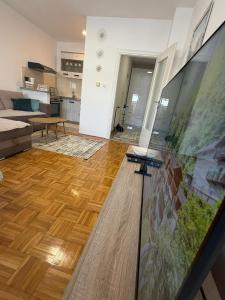 a living room with a couch and a table at MAAA Apartman in Tuzla