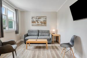 a living room with a couch and a table at Homeport Motel in Lunenburg