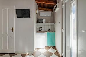 a small kitchen with a sink and a stove at T7 Garden guest house in Siófok
