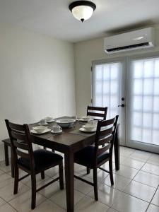 a dining room with a table and four chairs at Casa Antonio in Reynosa +8 photos