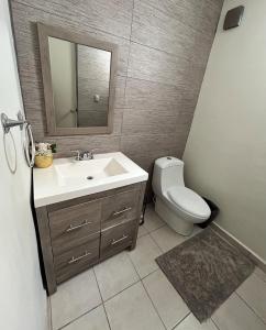 a bathroom with a sink and a toilet at Casa Antonio in Reynosa
