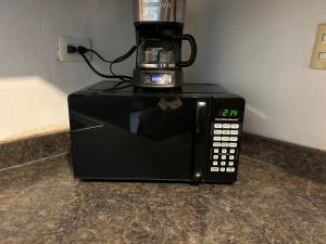 a black microwave with a coffee pot on top of it at Casa Antonio in Reynosa