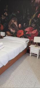 a bed in a room with a floral wall at Apartamento Marandel in Ronda +10 photos