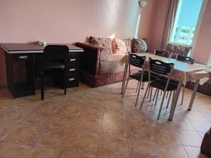 a living room with a table and chairs and a couch at HOTEL AZOuR in Agadir +6 photos