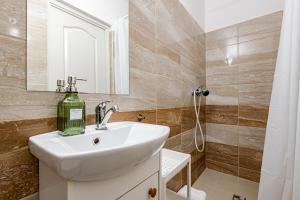a bathroom with a sink and a mirror and a shower at T7 Garden guest house in Siófok +70 photos