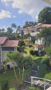 arial view of a house with palm trees and a yard at Oasis Marigot Bay in Marigot