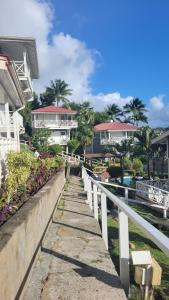 a walkway next to a building with houses at Oasis Marigot Bay in Marigot