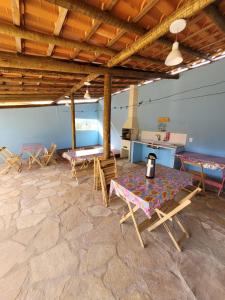 a room with a table and chairs and a stone floor at Casa Encantada in Sêrro
