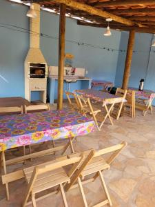 a group of tables and chairs in a room at Casa Encantada in Sêrro +8 photos