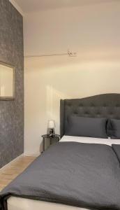 a bedroom with a large bed with a gray headboard at Wohnung Karl-Marx 1 in Trier