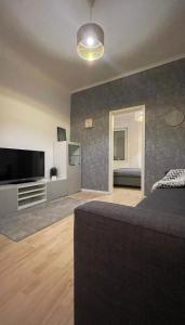 a bedroom with a bed and a flat screen tv at Wohnung Karl-Marx 1 in Trier
