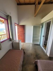 a room with a bed and a closet and a door at Casa Encantada in Sêrro