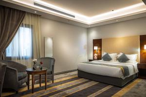 a hotel room with a bed and a chair at دار ود للشقق المخدومة Dar Wed in Jeddah +122 photos