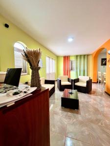 a lobby with a desk with a laptop on it at Casa BB&Djassi - SUITES in Ponta do Sol