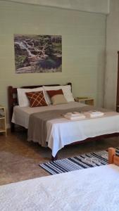 a bedroom with a large bed in a room at Beira Rio Casa Canastra in Vargem Bonita
