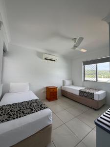 a bedroom with two beds and a window at QCWA K P Units in North Ward