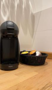 a coffee maker sitting next to a basket on a table at Wohnung Karl-Marx 2 in Trier