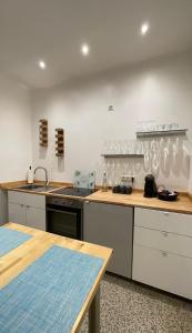 a kitchen with white cabinets and a counter top at Wohnung Karl-Marx 2 in Trier +11 photos
