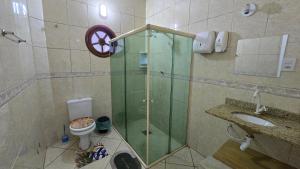 a bathroom with a shower with a toilet and a sink at Almar Hospedagem 2 ARRAIAL DO CABO in Arraial do Cabo