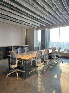 a conference room with a long wooden table and chairs at Luxury loft for 2 to 4 people in Monterrey