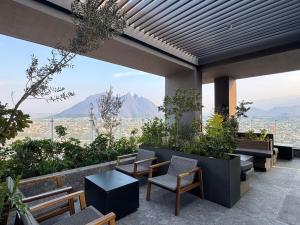 a patio with chairs and a view of a city at Luxury loft for 2 to 4 people in Monterrey