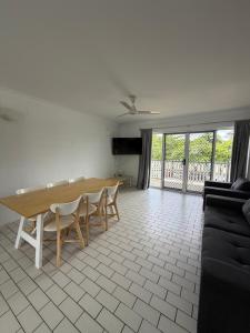 a living room with a wooden table and chairs at QCWA K P Units in North Ward