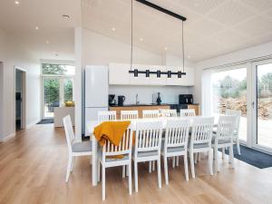a kitchen and dining room with a table and chairs at Saltum Beach Luxury & Wellness in Saltum