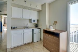 a kitchen with white cabinets and a sink at Paradise Plaza Inn in Ocean City
