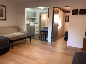 a living room with a couch and a kitchen at Marland Motel in Powell River