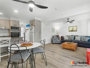 a kitchen and a living room with a table and chairs at Iluka Villa 2 in Iluka