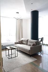 a living room with a couch and a table at Palm Vista Retreat in Durrës