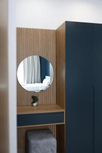 a room with a mirror on a wooden wall at Palm Vista Retreat in Durrës +11 photos