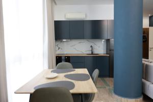 a kitchen with a wooden table and chairs in a room at Palm Vista Retreat in Durrës