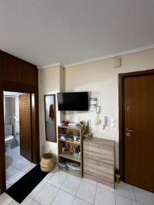a bathroom with a flat screen tv on the wall at Studio Kastra in Thessaloniki