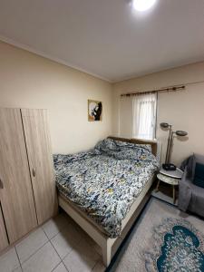a small bedroom with a bed and a chair at Studio Kastra in Thessaloniki