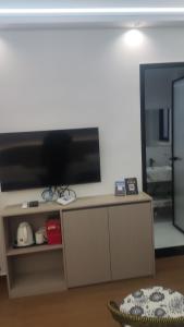 a living room with a large flat screen tv at 太溪民宿 in Zhangjiajie Hehua Airport