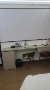 a room with a desk and two chairs and a table at 太溪民宿 in Zhangjiajie Hehua Airport