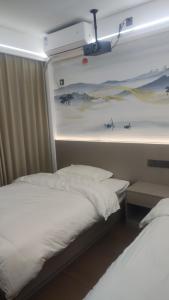 a bedroom with a bed and a wall with a painting at 太溪民宿 in Zhangjiajie Hehua Airport